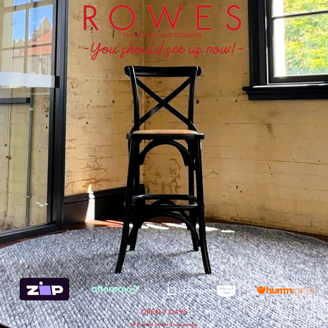 Black wooden chair in a room with large windows and 'Rowes' branding.