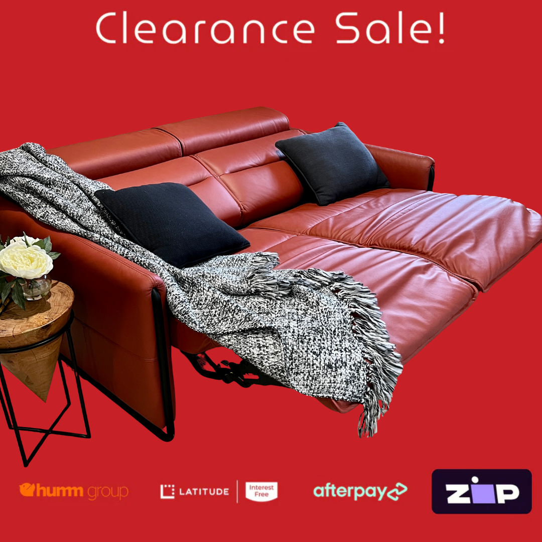 Red leather sectional sofa with a blanket and pillows on a red background, featuring clearance sale text and payment logos.