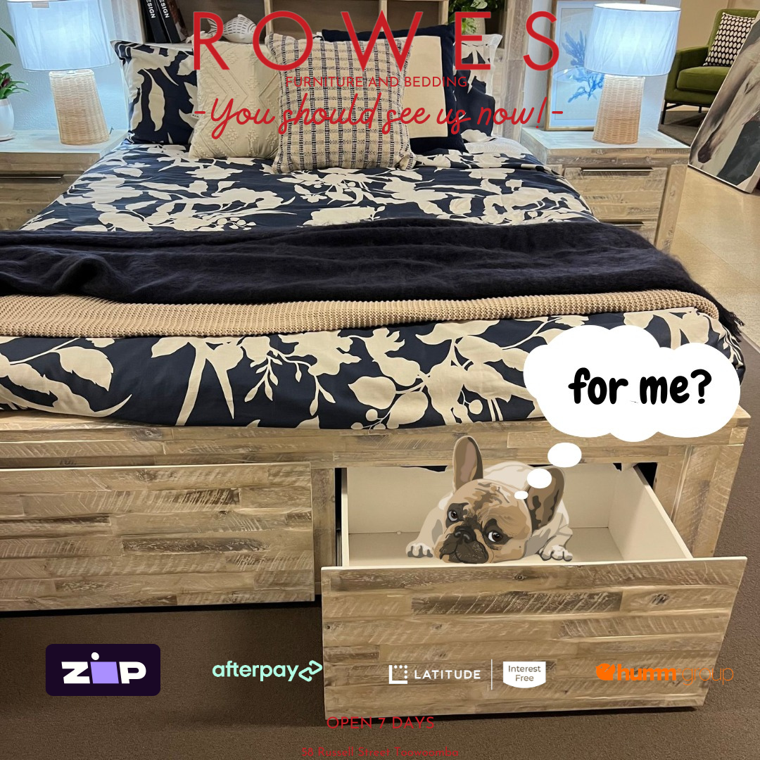 Bed with floral bedding and wooden drawers, dog inside one of the drawers, promotional text overlay.
