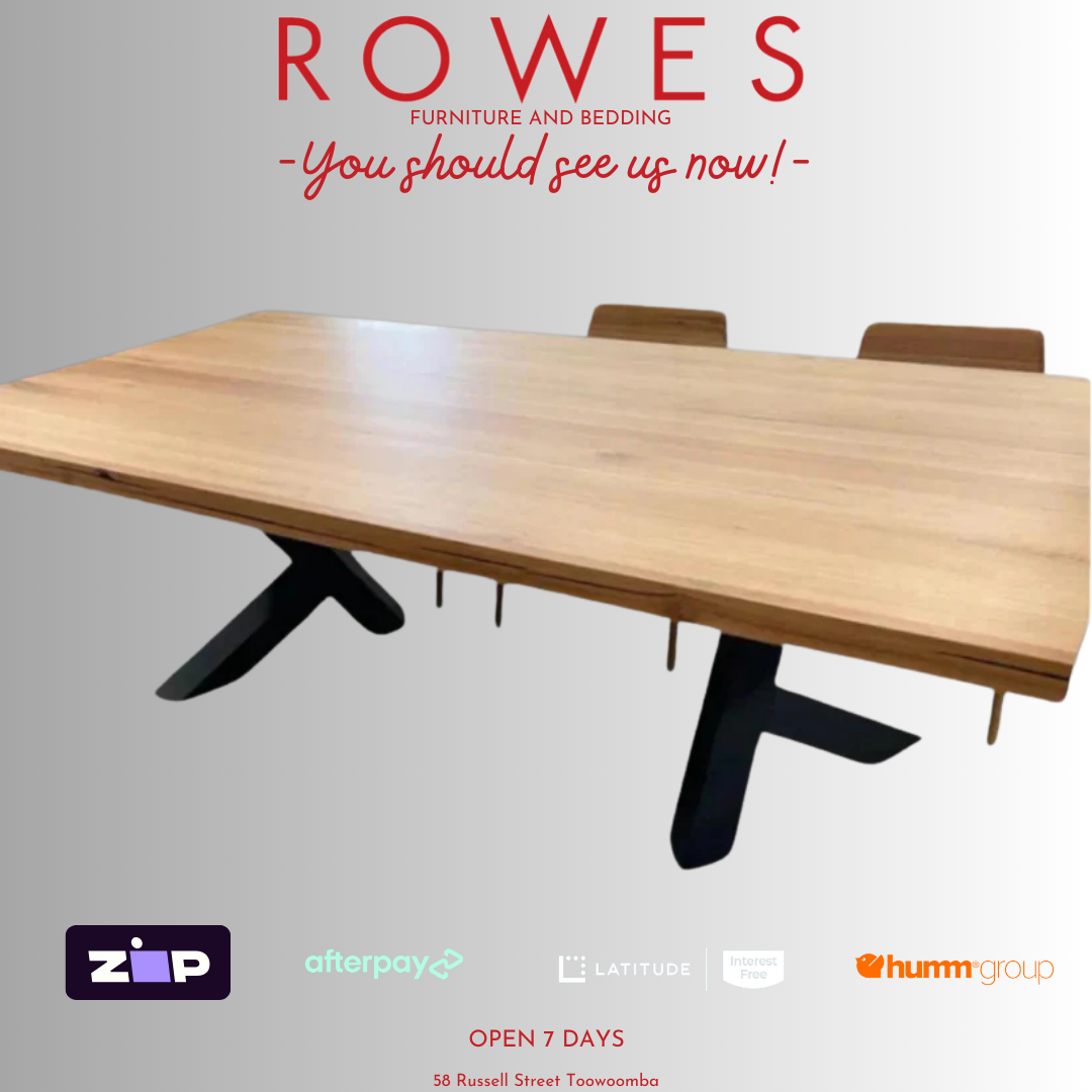A promotional image of the Metallico dining table with a thick Messmate timber tabletop and a unique metal leg pair in a gloss finish.
