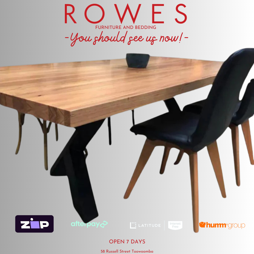 A promotional image of the Metallico dining table with a thick Messmate timber tabletop and a unique metal leg pair in a gloss finish.