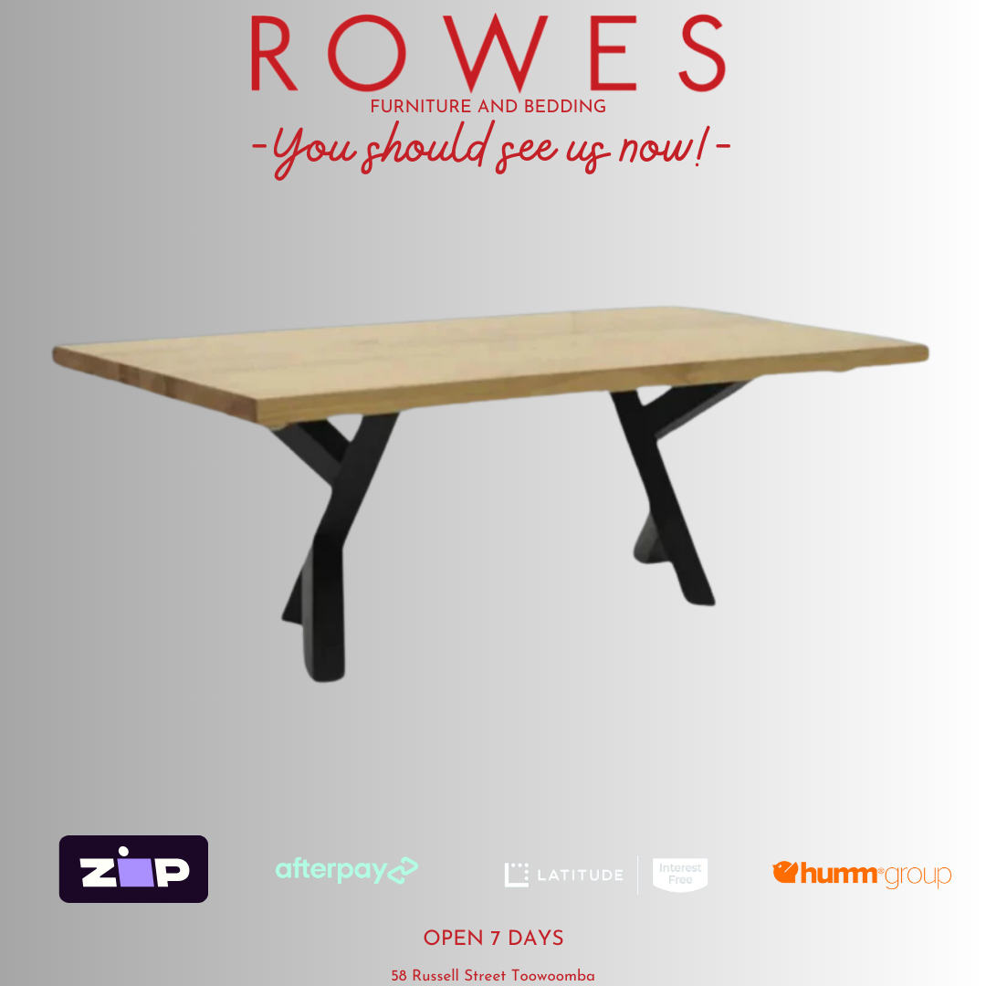 A promotional image of the Metallico dining table with a thick Messmate timber tabletop and a unique metal leg pair in a gloss finish.