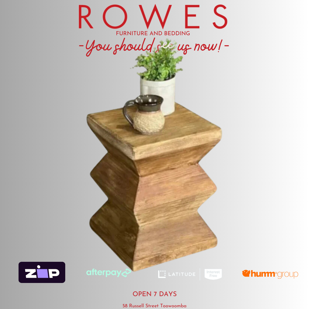 A wooden bedside stool made of recycled pine, with visible natural cracks and knots, placed on a white background with a small potted plant on top.