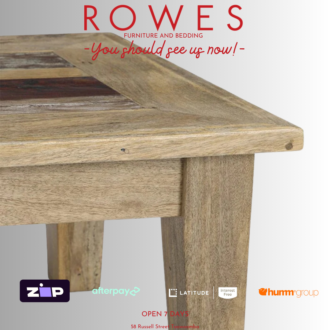 Wooden table with 'Rowes Furniture and Bedding' advertisement on a gray background