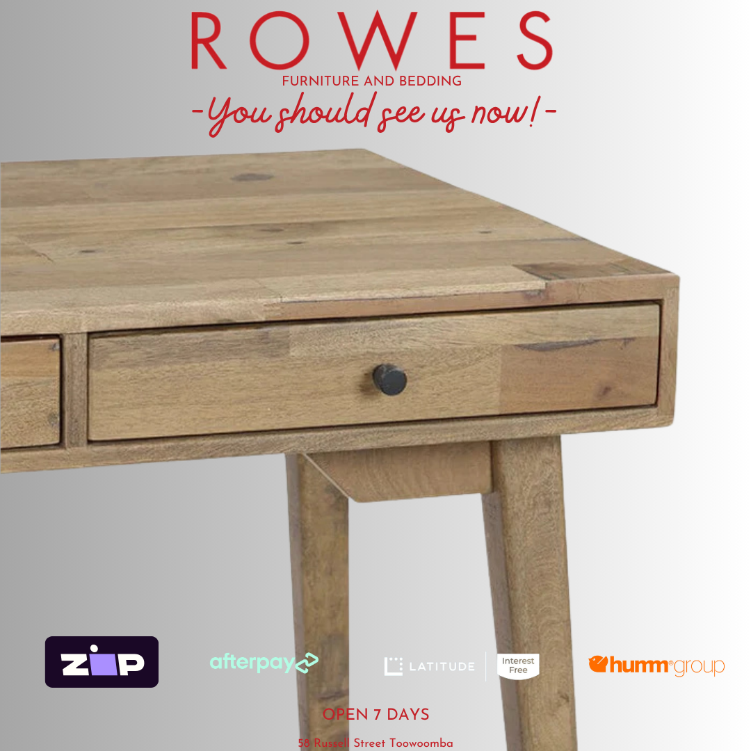 Wooden desk with 'Rowes Furniture and Bedding' text and logos on a light gray background