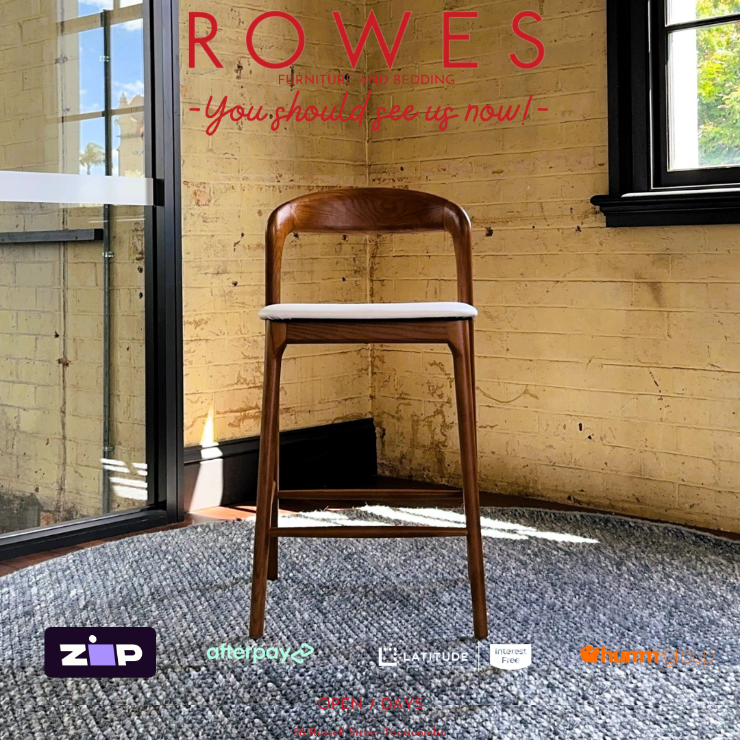 Wooden chair on a gray rug with 'Rowes' branding and promotional text.