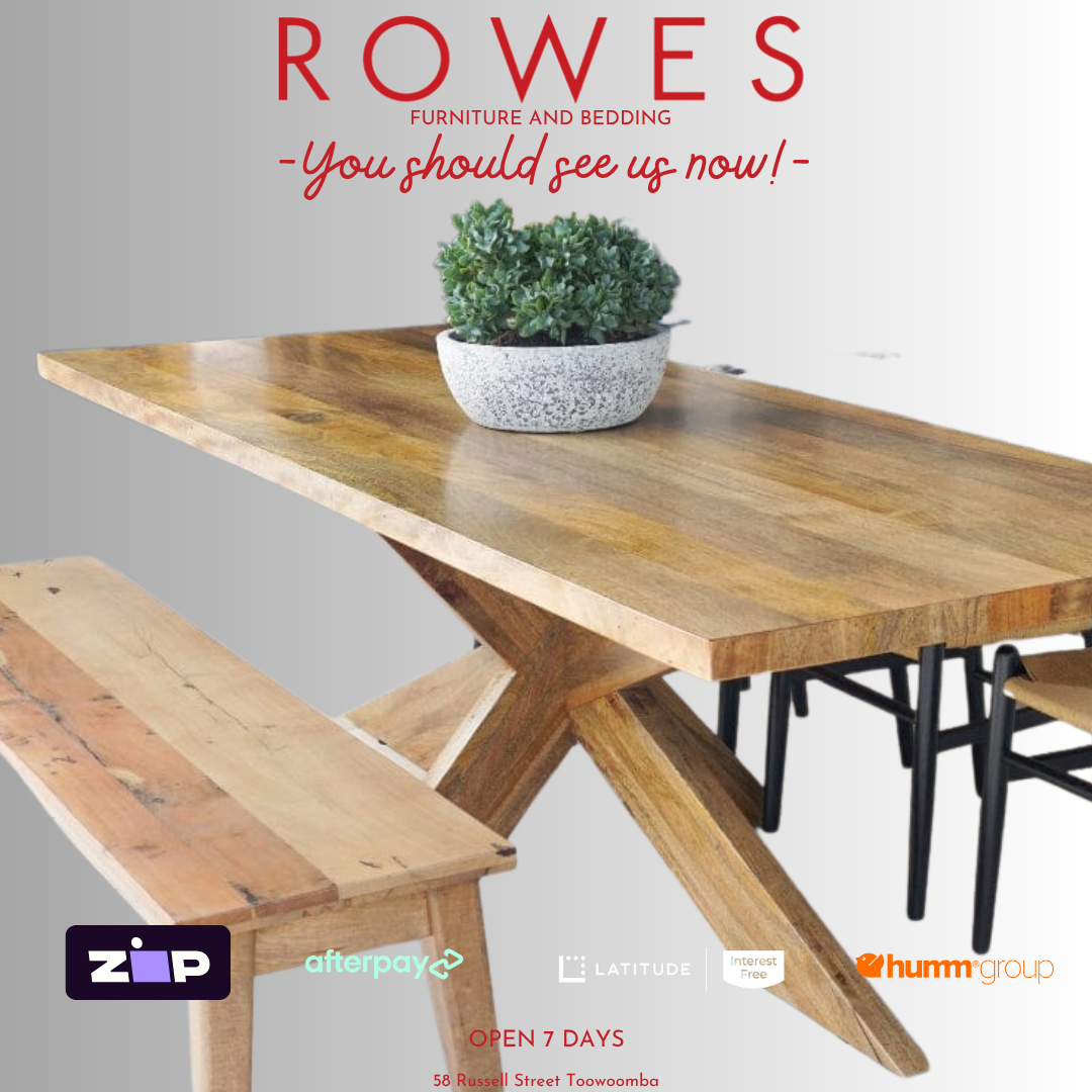 Wooden dining table with bench and potted plant on a gray background, featuring 'Rowes' furniture and bedding advertisement.