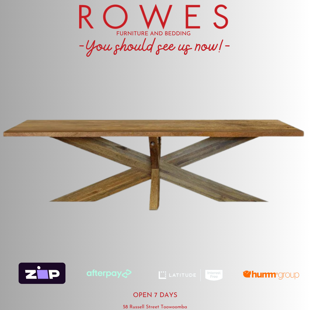 Wooden dining table with 'Rowes Furniture and Bedding' advertisement on a white background