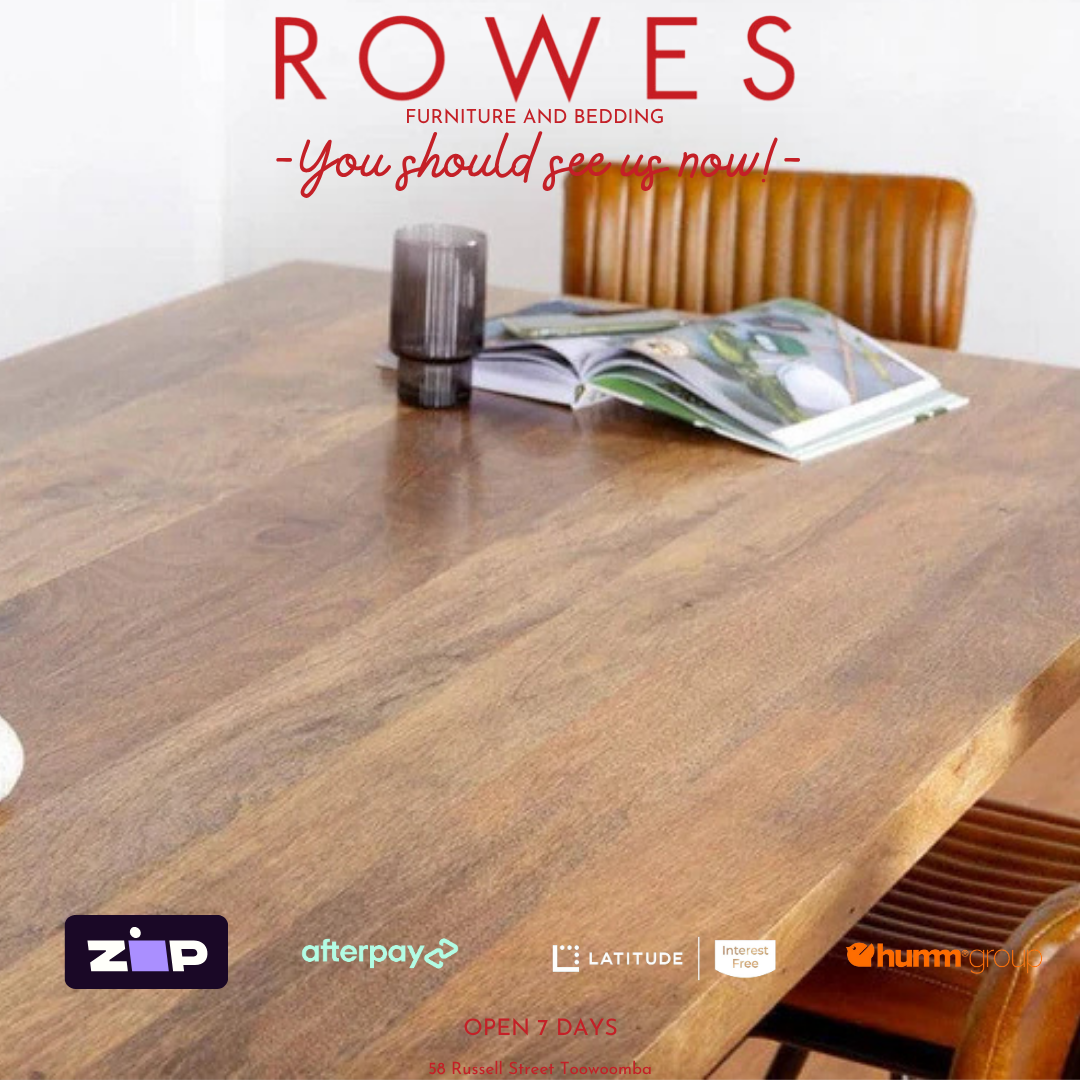 Wooden dining table with a chair, magazine, and glass on a white background with 'ROWES' branding.