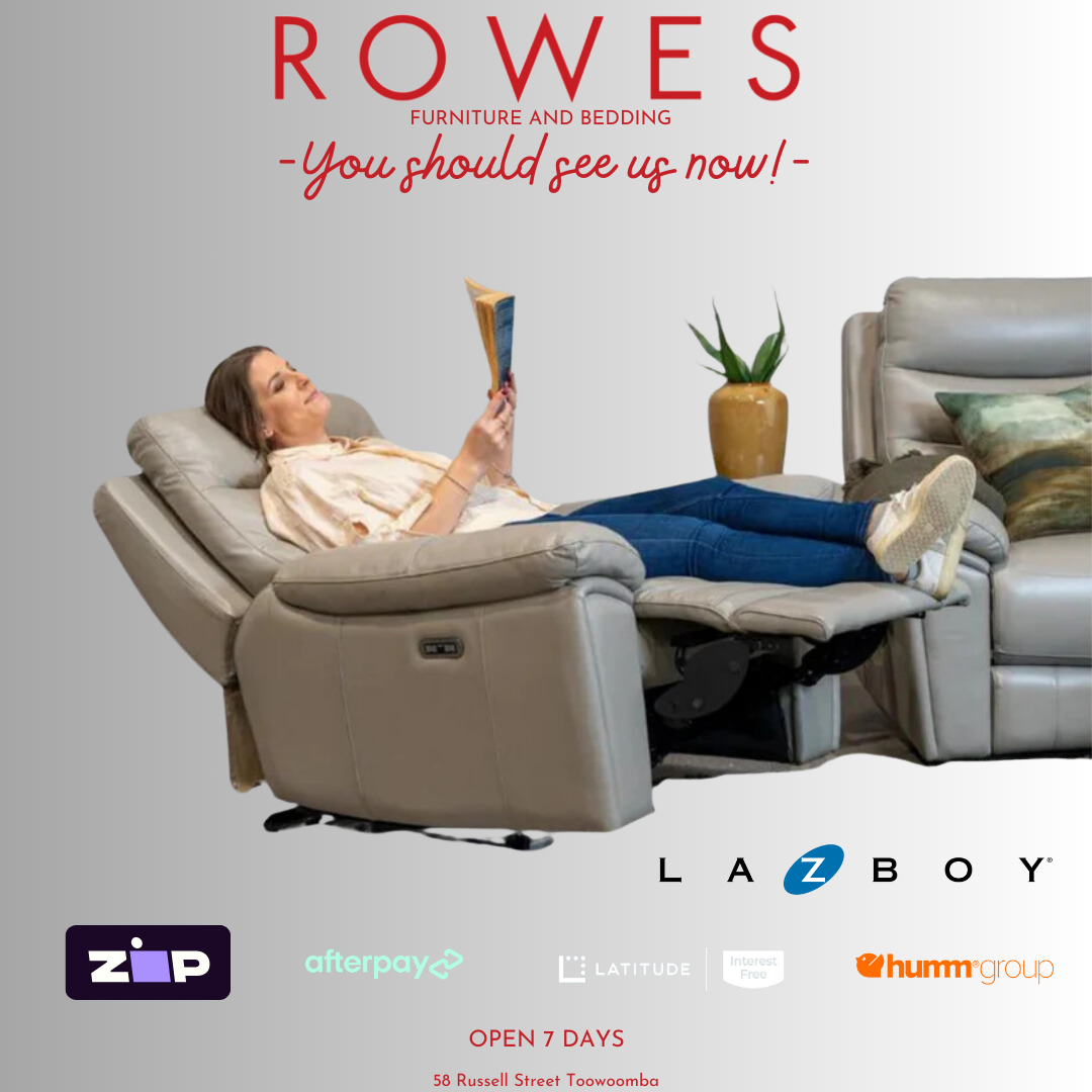 A person relaxing in a LaZboy Derby power reclining chair, with the chair in a fully reclined position, showcasing the comfort and design of the chair.