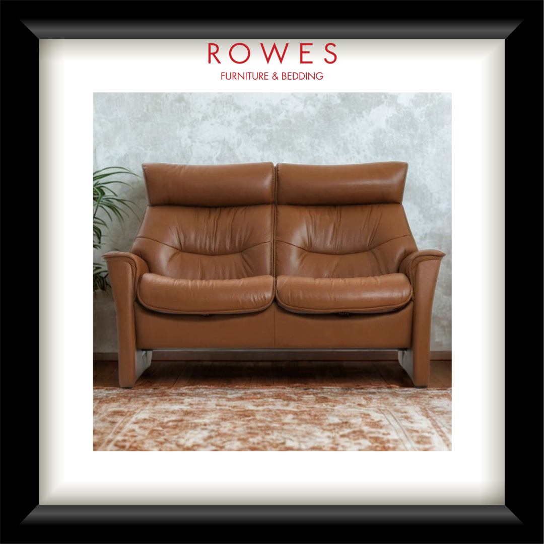 Brown leather sofa in a room with 'Rowes Furniture & Bedding' branding.