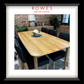 An oak dining table in a comfortable room with leather dining chairs and the Rowes branding