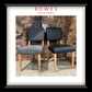 A framed image of two dining chairs, one leather and one fabric, on a tiled floor against a brick wall. The frame features the Rowes branding.