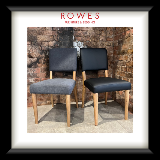 A framed image of two dining chairs, one leather and one fabric, on a tiled floor against a brick wall. The frame features the Rowes branding.