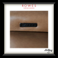 A framed close-up photograph of a brown upholstered surface with a black rectangular control panel inset, presented with a white mat and black frame. Visible text includes 'ROWES FURNITURE & BEDDING' at the top and 'LaZboy' at the bottom right.