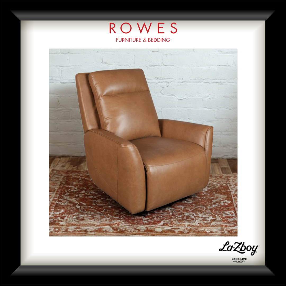 A framed product display featuring a tan leather recliner chair in a styled room scene with a white brick wall and patterned rug. The frame includes the text 'ROWES FURNITURE & BEDDING' at the top and 'LaZboy' at the bottom right.
