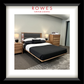 Bedroom setup with bed, nightstands, and dresser in a room with 'Rowes Furniture & Bedding' branding.