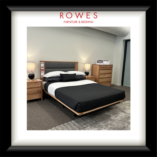 Bedroom setup with bed, nightstands, and dresser in a room with 'Rowes Furniture & Bedding' branding.
