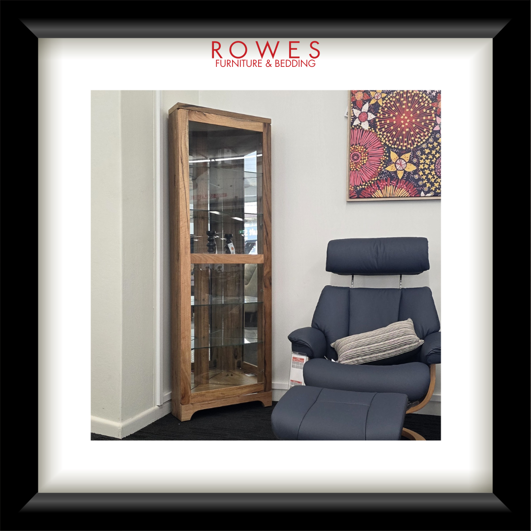Furniture store display with a blue armchair and wooden cabinet, featuring Rowes Furniture & Bedding logo.