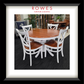 A white dining table surrounded by matching chairs. The top of the dining table and the seats of the chairs are all natural timber coloured. The Rowes branding is prominent. 