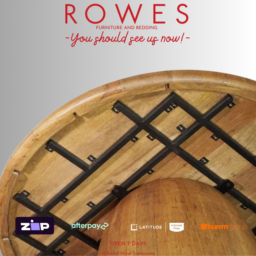 Wooden table with steel frame support on a gray background, featuring 'Rowes' furniture and bedding advertisement.