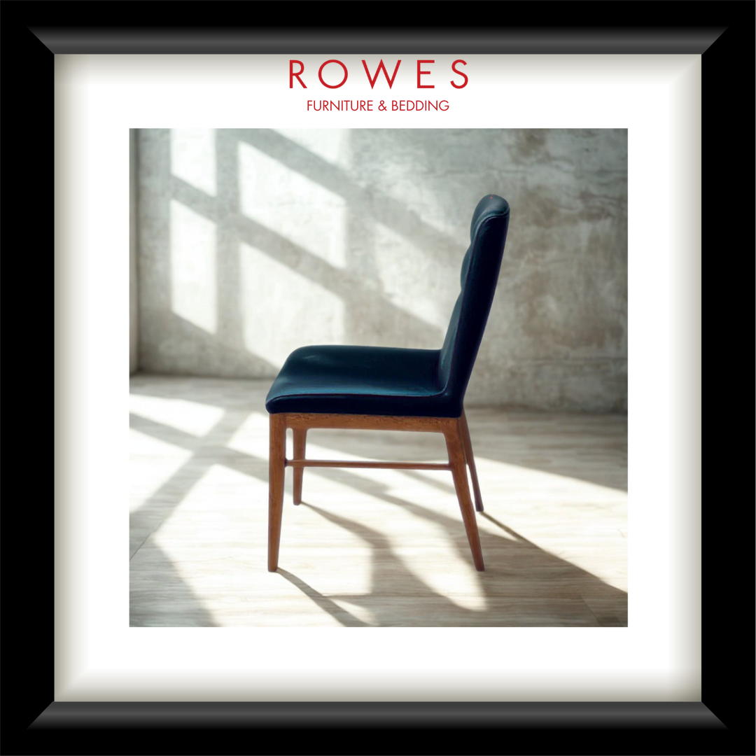 A luxurious black leather dining chair with timber legs in a large room, featuring the Rowes logo