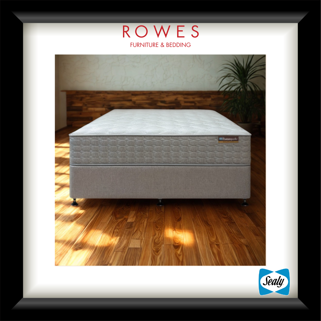 Mattress on a wooden floor with 'Rowes Furniture & Bedding' branding.