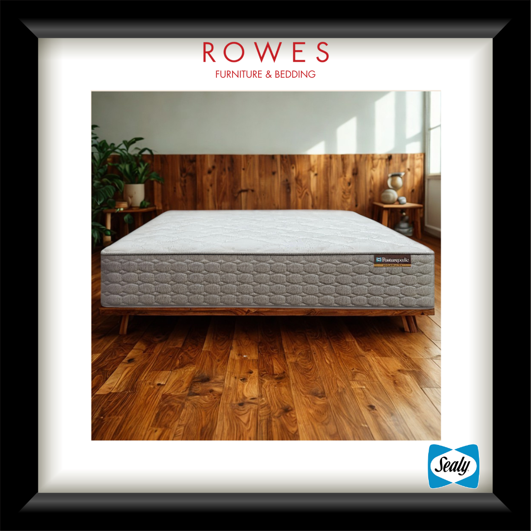 Gray mattress on a wooden bed frame with 'Rowes Furniture & Bedding' branding.