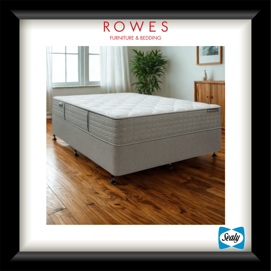 Gray mattress on a wooden floor with 'Rowes Furniture & Bedding' branding.