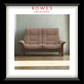 Brown sofa in a room with 'Rowes Furniture & Bedding' branding.