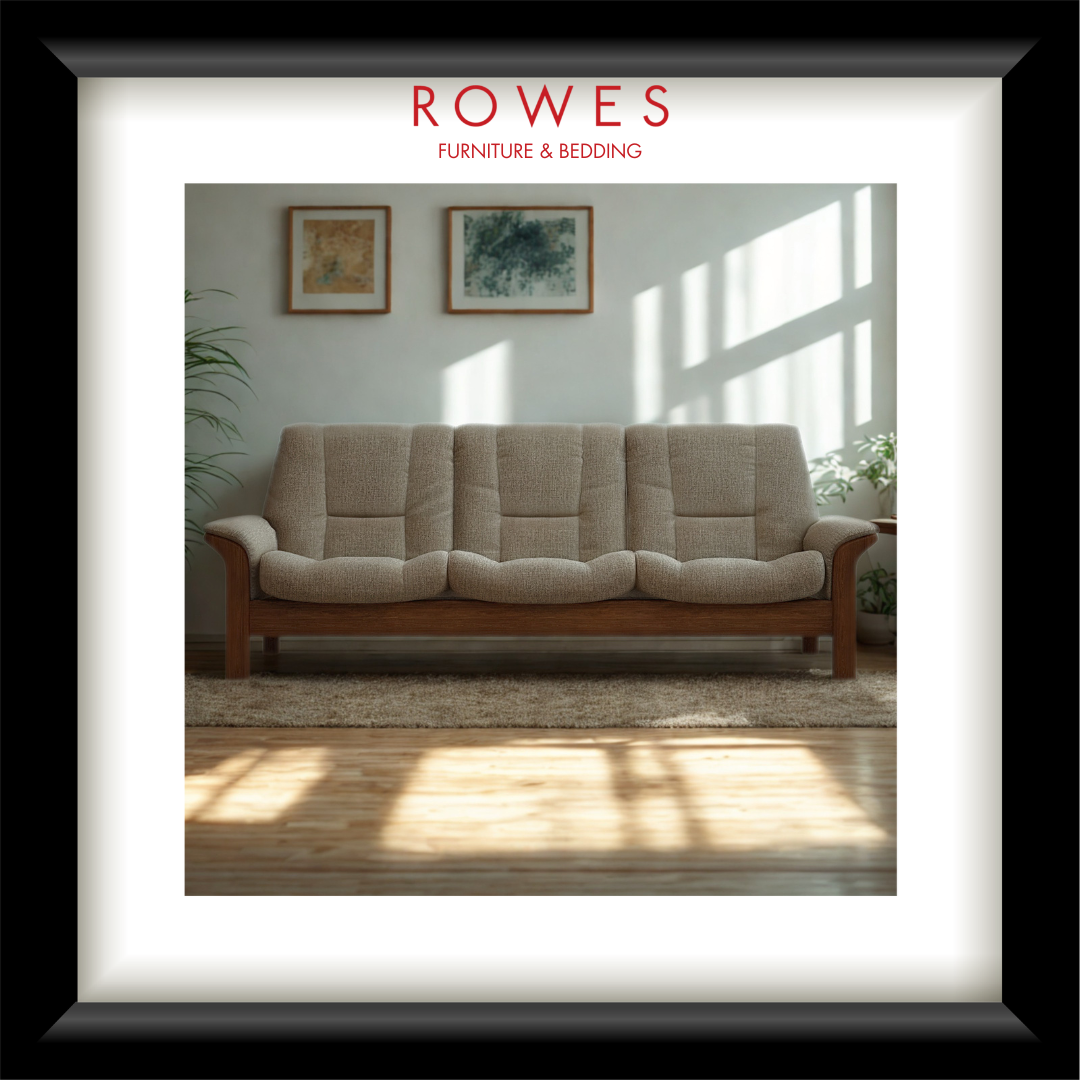 Beige sofa in a room with sunlight streaming through a window, featuring the Rowes Furniture & Bedding logo.