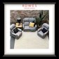 Living room setup with gray chairs and a small table against a brick wall, featuring Rowes Furniture & Bedding branding.