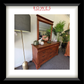 Wooden dresser with mirror and lamp in a room setting, featuring Rowes Furniture & Bedding logo.