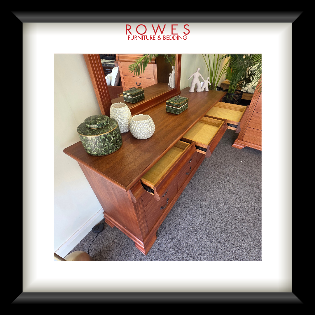 Wooden dresser with ceramic items on top, branded 'Rowes Furniture & Bedding'.