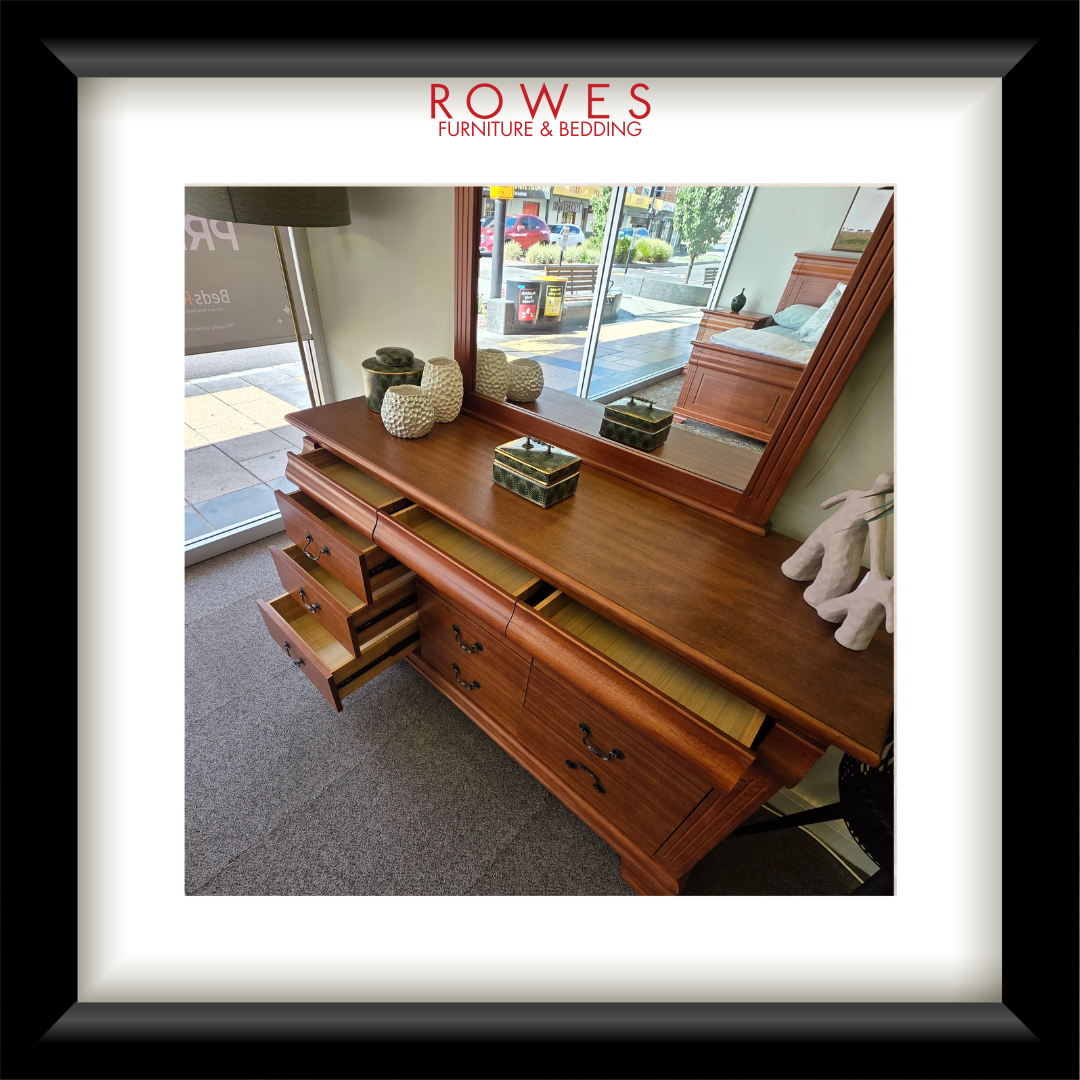 Wooden dresser with open drawer in a room setting, featuring Rowes Furniture & Bedding logo.