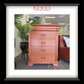 Wooden dresser with 'Rowes Furniture & Bedding' logo in a room setting.
