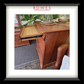 Wooden desk with a tray pulled out, featuring Rowes Furniture & Bedding logo.