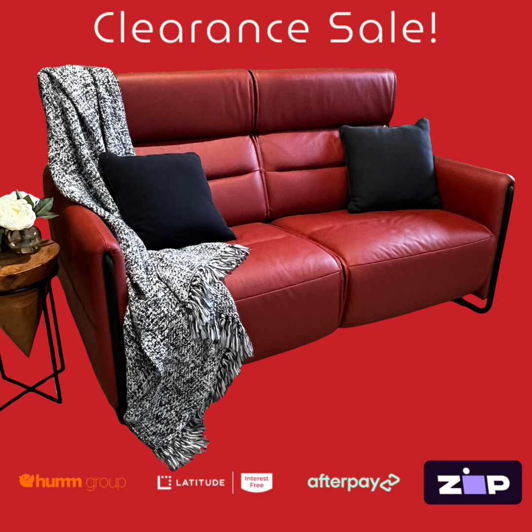 Red leather sofa with a blanket and pillows on a red background, featuring clearance sale text and payment logos.