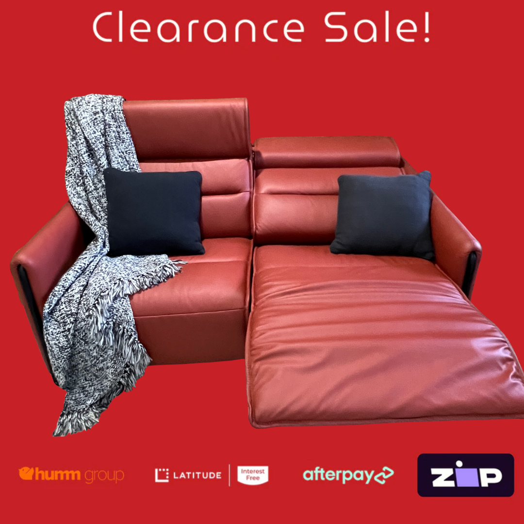 Red sectional sofa with cushions and a blanket on a red background, featuring clearance sale text and payment logos.