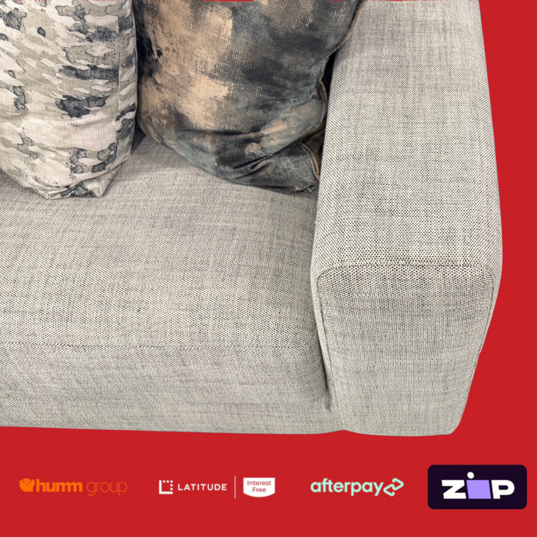 Gray sofa with camouflage pillows on a red background featuring payment brand logos.