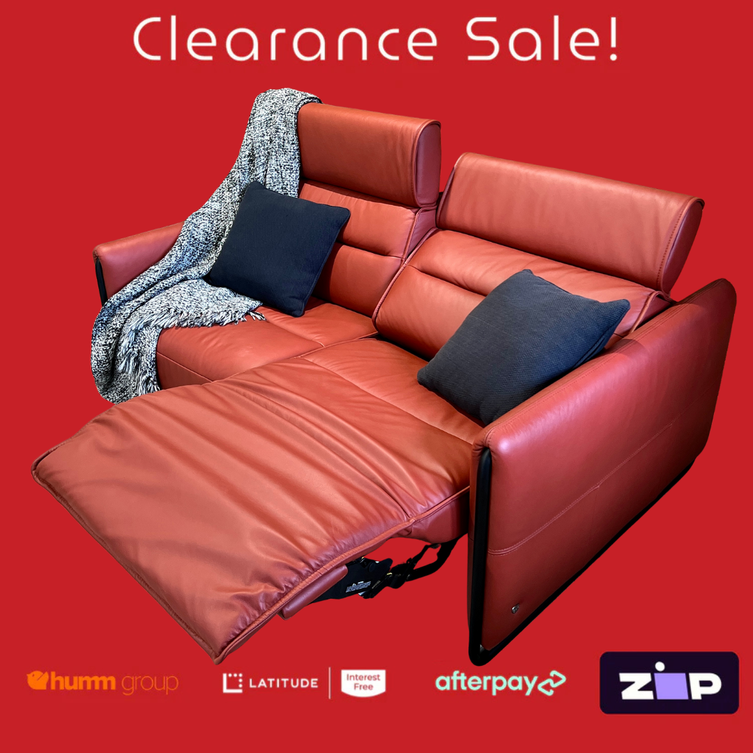 Red sectional sofa with cushions on a red background, featuring clearance sale text and payment logos.