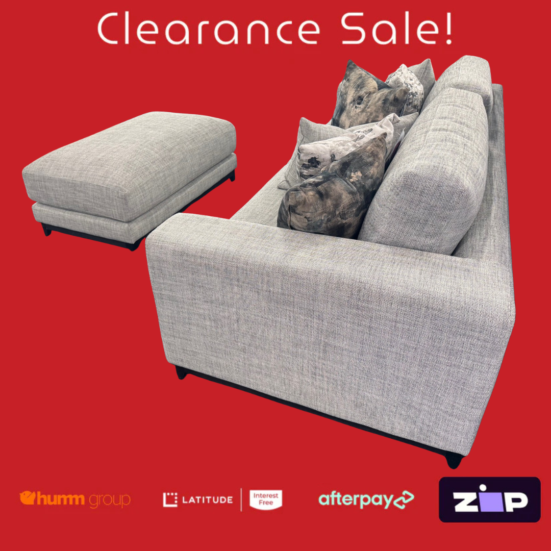 Gray sofa with ottoman on a red background with clearance sale text