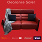 Red leather sofa with black pillows and a blanket on a red background, featuring clearance sale text and payment logos.