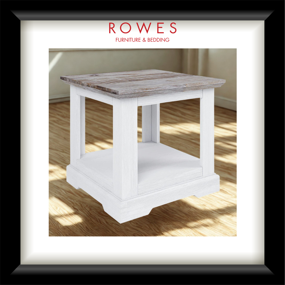 A framed product photo of a small end table with a white distressed base and a weathered gray-brown wood top, shown inside a black frame with a white mat. The brand name 'ROWES FURNITURE & BEDDING' is printed at the top of the image.