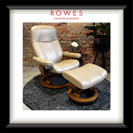 Cream-colored leather recliner chair with ottoman on a textured rug, with 'Rowes Furniture & Bedding' branding.