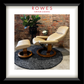 Beige recliner chair and ottoman with a plant and small table against a brick wall, branded 'Rowes Furniture & Bedding'.