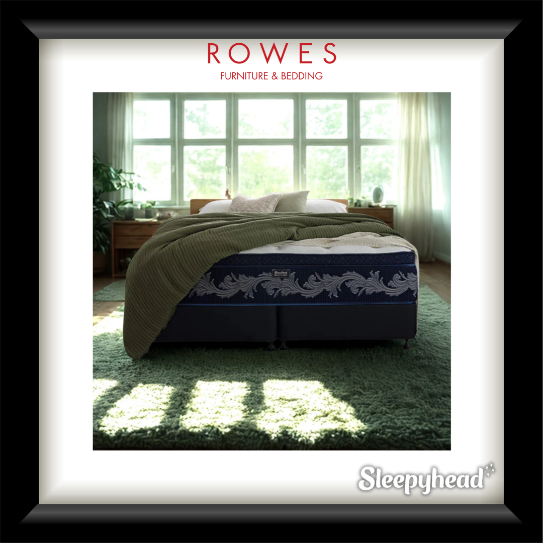 Bed with green blanket in a bright room, featuring Rowes Furniture & Bedding branding.