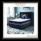 Navy blue bed with decorative pillows in a bedroom setting, featuring Rowes Furniture & Bedding branding.