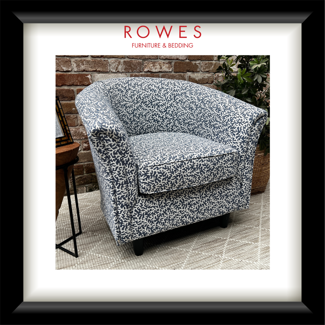 Floral-patterned armchair in an outdoor setting with 'Rowes Furniture & Bedding' branding.