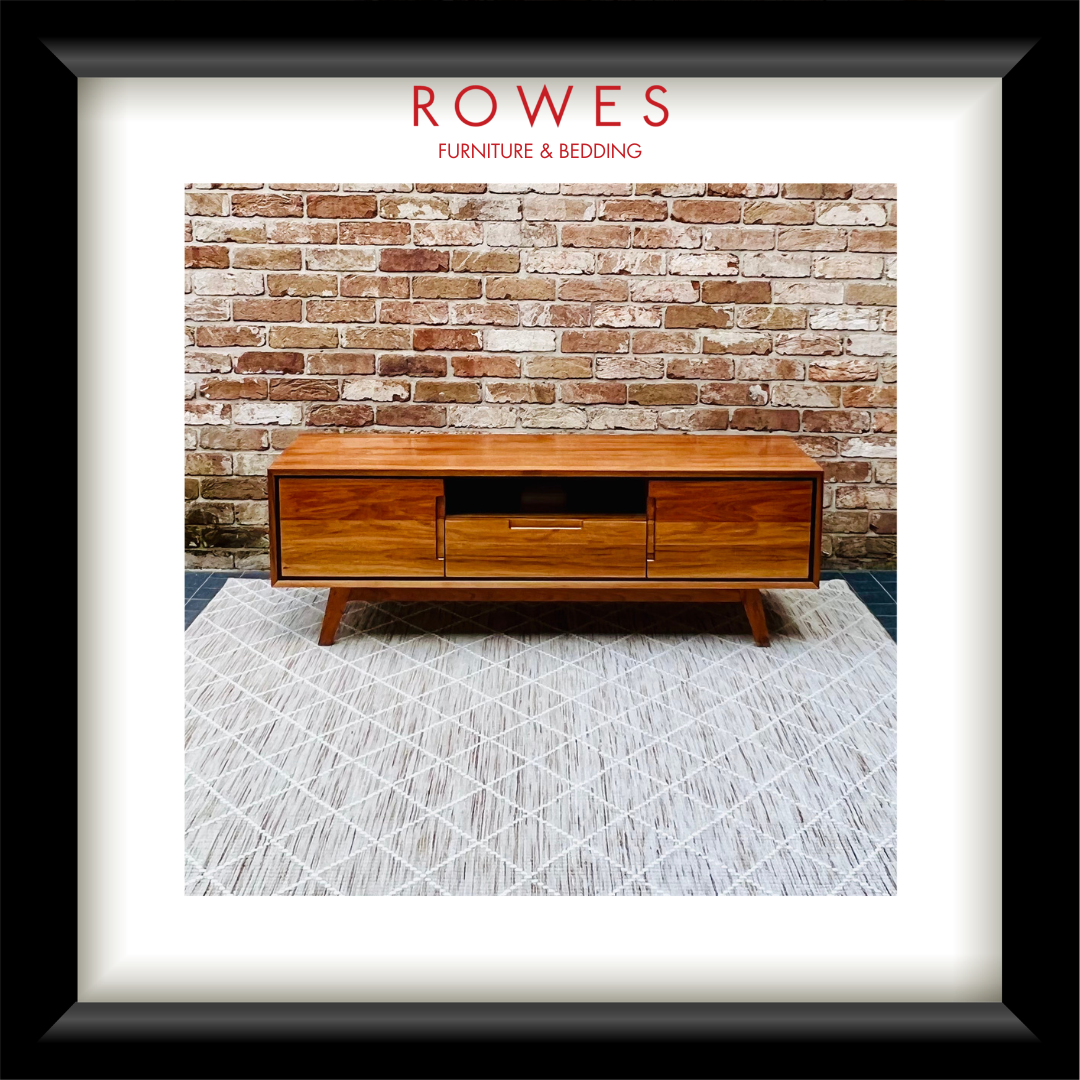 An entertainment unit on a beige rug set against a brick wall with the Rowes branding.